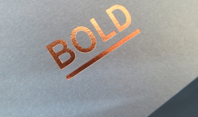 BOLD in copper metallic with underline on gray card
