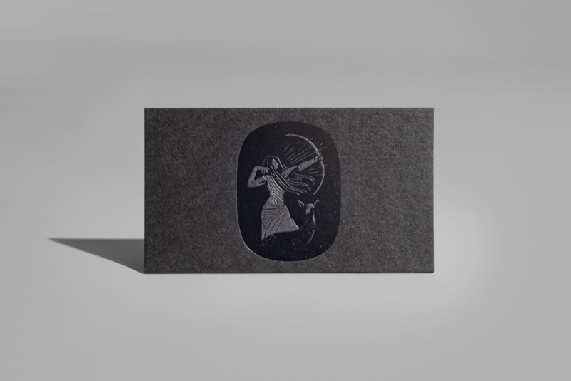 Gloss black foil emblem on charcoal card
