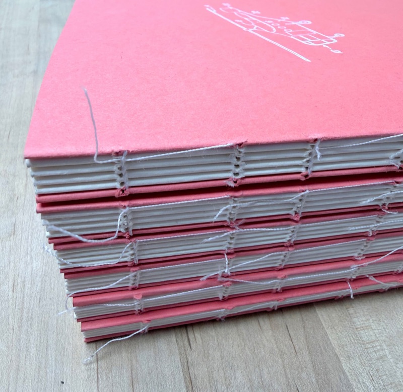Pink books with exposed Smyth-sewn spines