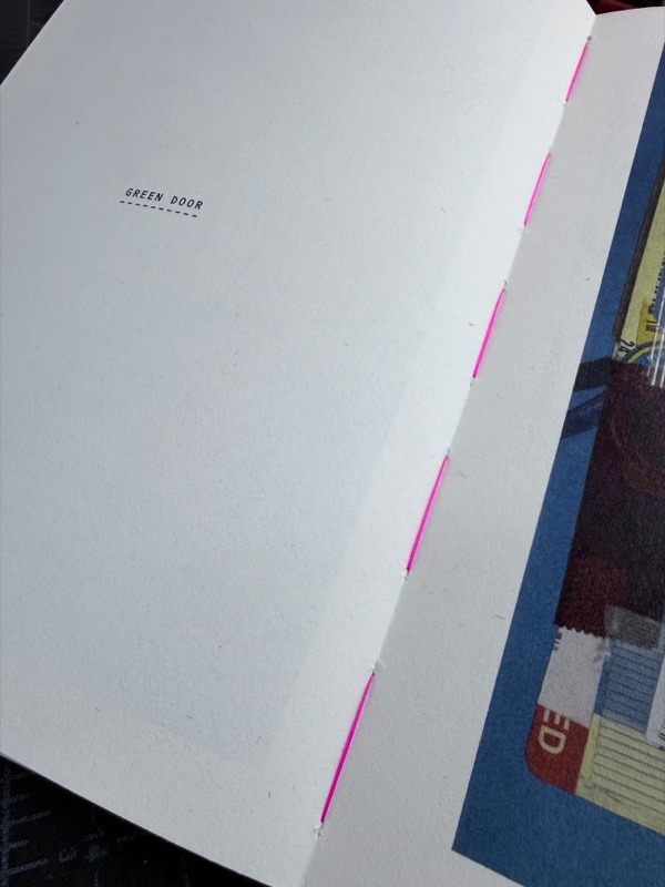 Neon pink thread sewn through the fold