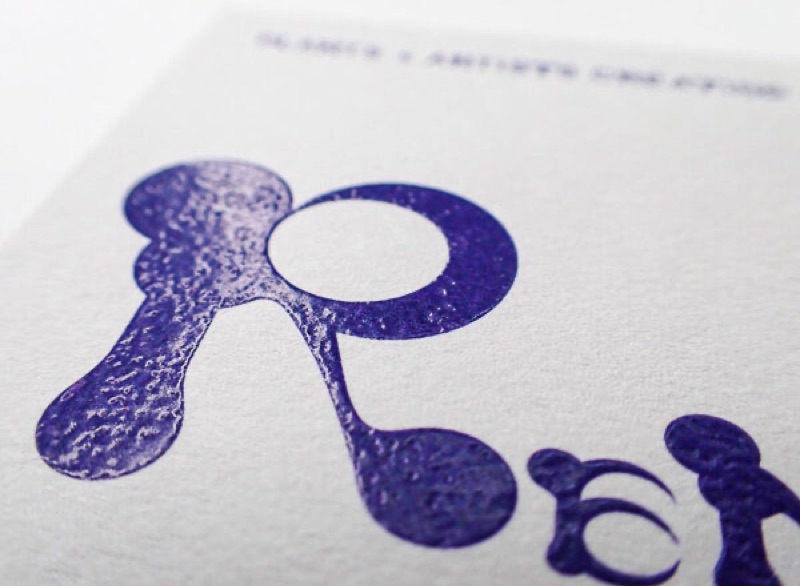 Purple thermography lettering with visible raised texture