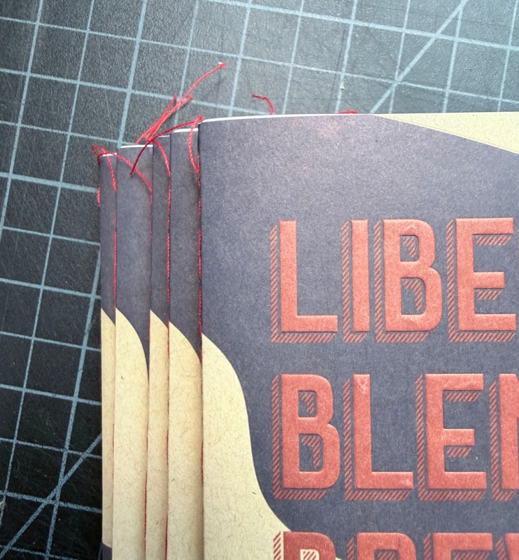 Singer sewn kraft booklets with loose thread tails