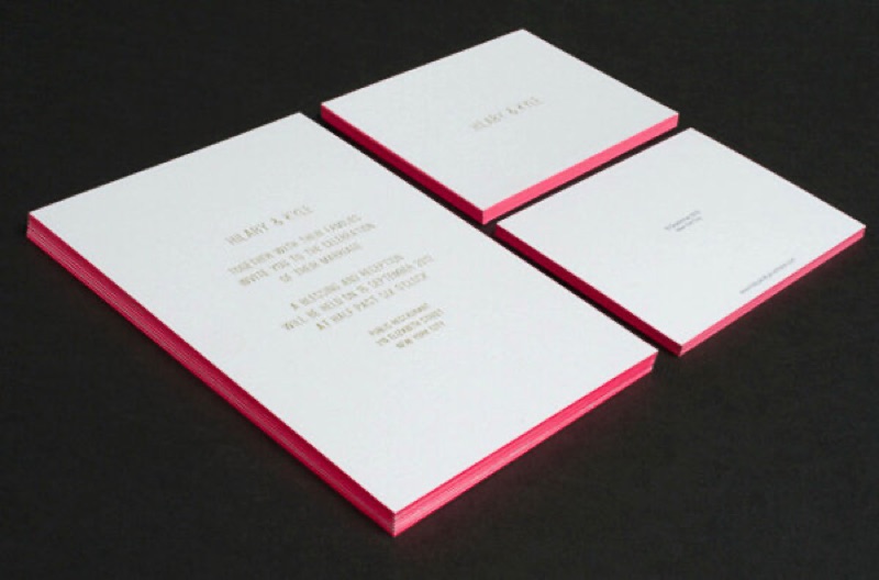 Wedding invitation suite with gold type and pink painted edges
