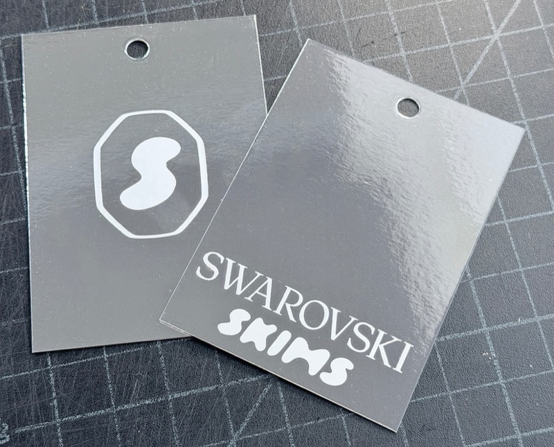 White ink on silver mirror hang tags
