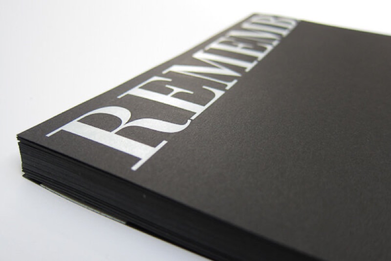 White ink wordmark on black cardstock folder