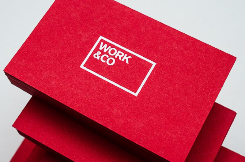 White letterpress logo on red business cards